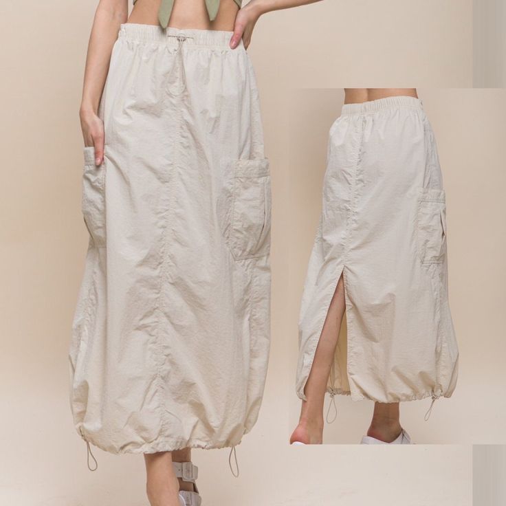 "This utility midi skirt has a vintage 80s and 90s inspired design with a toggle tie waist and side pockets. It is made of a lightweight, windbreaker fabric and features a back slit and parachute cargo style. Small (2/4), Medium (6/8), Large (10) everything was measured laid flat, LENGTH: 35-35.5\" on all sizes Small   -waist is 28.5\" without stretch.   -hips: 41\" medium    -waist: 29\"   -hips: 42\" large    -waist: 30\"   -hips: 42.5\" The fabric is water resistant and lightweight, perfect for everyday wear. The toggle tie waist and side pockets give it a unique and functional look. Available in Black, Cream, Taupe and Olive from Size Small to Large Model is Wearing Size Small. Model: 5'9\"  32C bust, 25\" waist, and 36\" hips.  Color may vary slightly due to monitor resolution  Self: Bestie Holiday, Stretch Hips, Parachute Cargo, Mini Pencil Skirt, Cozy Tops, Style Finder, Cargo Style, Cargo Skirt, 90s Retro