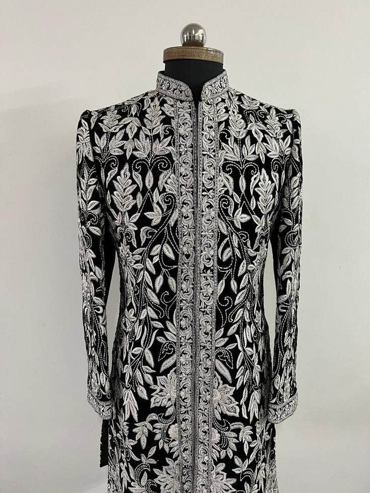 Garb yourself in a stunning masterpiece by Sherwanionline.This sherwani is meticulously handcrafted on a raw silk material in black colour. It has detailed and continuous white thread handwork. It has a mandarin collar which is highlighted with contrasting embroidery.This sherwani not only accentuates your personal style quotient but also fits into everything conventional and heirloom. Includes- sherwani and bottom  Colour options available. Customisation available. Designer Formal Bandhgala With Dabka Work, Designer Bandhgala With Dabka Work For Formal Events, Designer Bandhgala With Dabka Work For Formal Occasions, Designer Embroidered Fitted Bandhgala, Elegant Bandhgala With Resham Embroidery For Diwali, Luxury Fitted Ceremonial Set, Designer Nehru Jacket With Dabka Work For Formal Events, Designer Nehru Jacket With Dabka Work For Formal Occasions, Designer Formal Nehru Jacket With Dabka Work