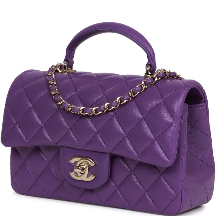 This Mini Rectangular flap bag is in purple lambskin with light gold tone hardware and has a front flap with signature CC turnlock closure, rear half moon pocket, top handle and single interwoven purple leather and light gold tone chain link shoulder/crossbody strap. The interior is lined in purple leather and features a zipper pocket with Chanel pull and an open pocket below. Collection: 22A Origin: France Condition: Pristine; new or never Accompanied by: Chanel box, Chanel dustbag, felt, carebook and ribbon Measurements: 8.5" width x 6" height x 3" depth; 1.77" top handle, 22.5" strap drop Chanel Mini Rectangular, Purple Purse, Chanel Box, Purple Quilts, Chanel Mini, Purple Leather, Purple Bags, Pocket Top, Quilted Leather