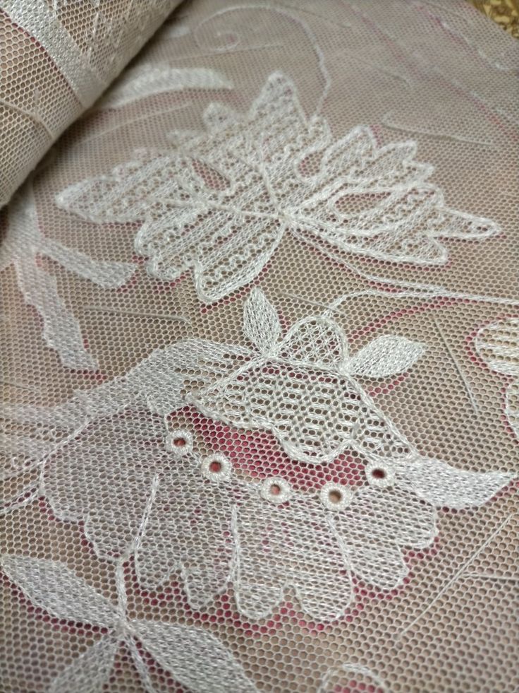 the fabric is white and has pink flowers on it