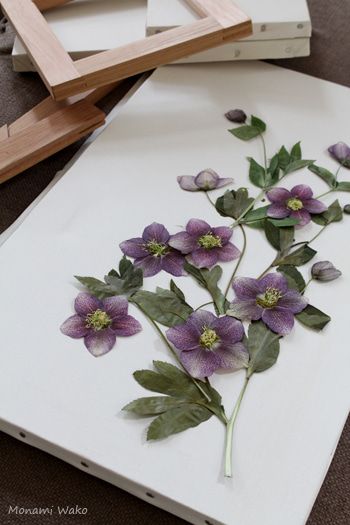 some purple flowers are on a white board