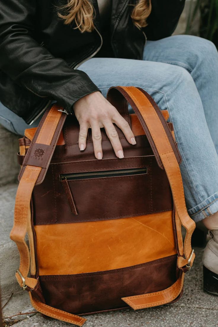 This Leather Backpack is the perfect way to travel for your meetings, work trips or everyday errands!Dimensions:14" W x 17" HFeatures:• Fits 13" laptop• Interior slots and zipper pocket• Exterior zipper pocket on back• Natural brass closures• Adjustable Leather straps Laptop Backpack With Luggage Sleeve For Commuting, Laptop Backpack With Zipper Closure For Travel, On-the-go Laptop Backpack With Zipper Pocket, Travel Laptop Bag With Sleeve In Standard Backpack Shape, Commuting Laptop Backpack With Luggage Sleeve, Travel Laptop Bag With Sleeve, Travel Laptop Bag With Laptop Sleeve, Standard Travel Laptop Bag With Laptop Sleeve, Laptop Backpack With Zipper For Trips