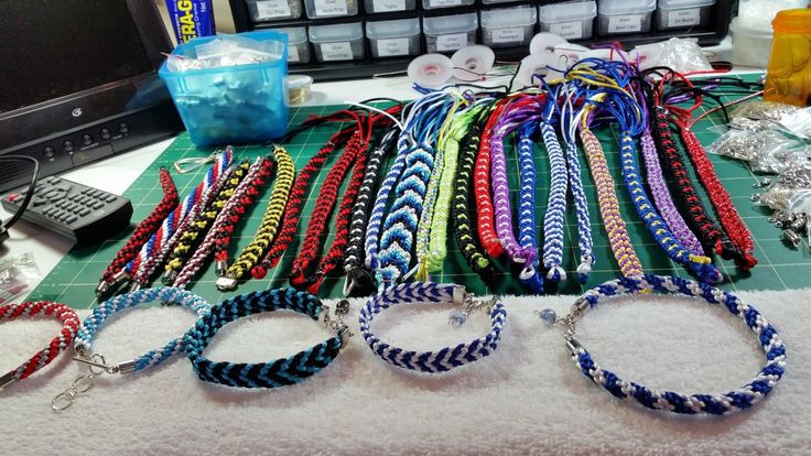 several bracelets are laid out on a table next to a television and remote control