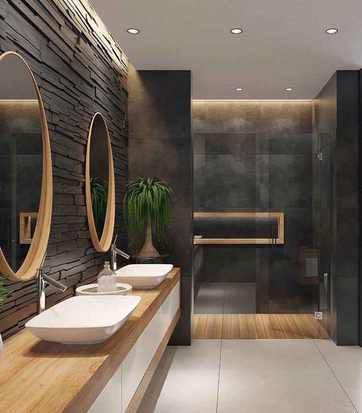 a modern bathroom with two sinks and mirrors