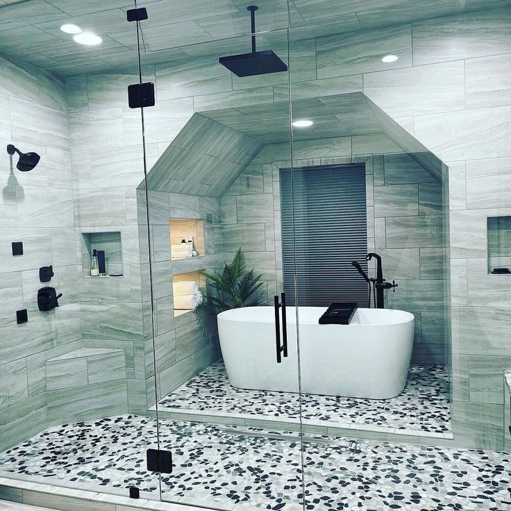 a bathroom with a white bathtub sitting next to a walk in shower