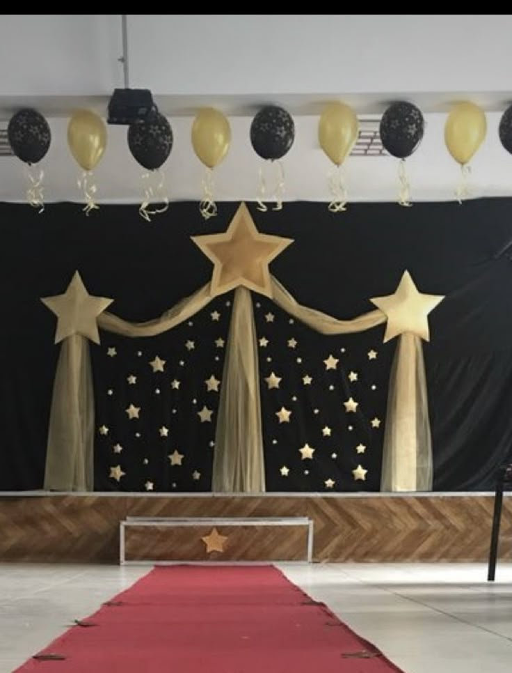 a stage set up with balloons and stars