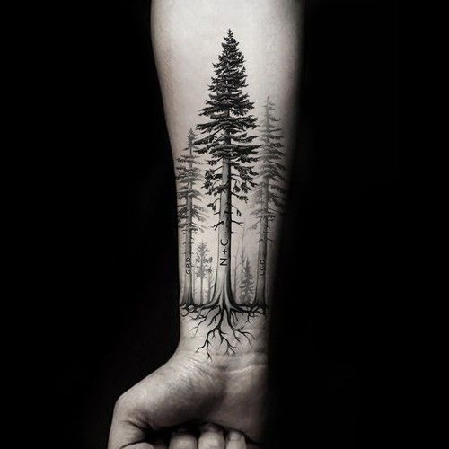 a person holding their arm with a tree on it and roots growing out of the trees