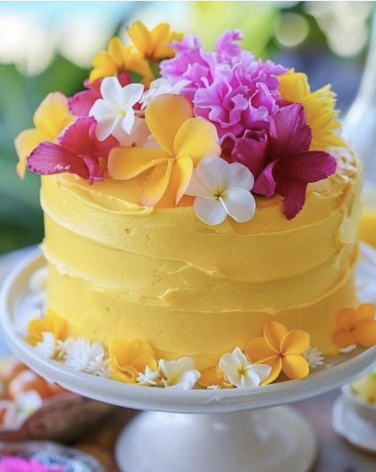 there is a yellow cake with flowers on it