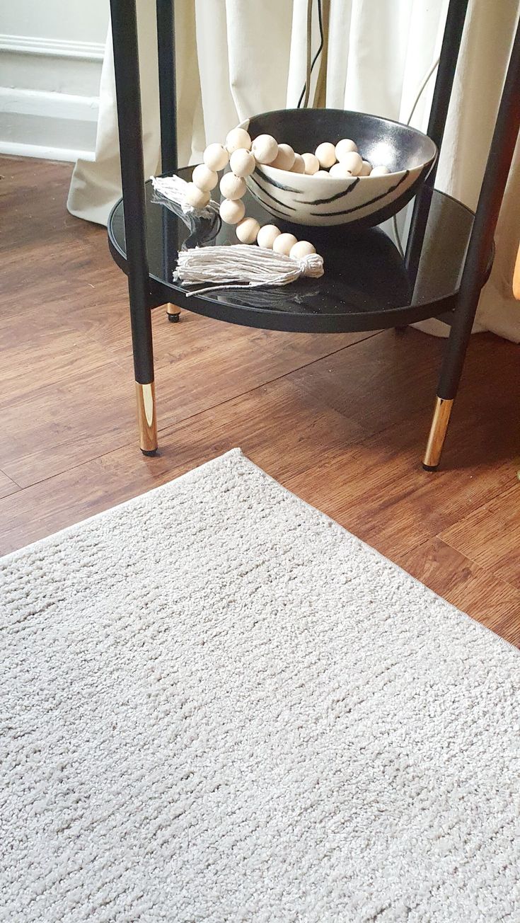 a table with some food on it and a rug in front of the table next to it