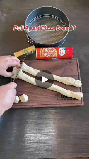 a person cutting up some food on top of a wooden table with a spatula