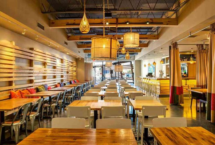 an empty restaurant with wooden tables and chairs