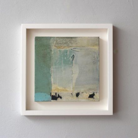 a painting hanging on the wall in a white frame