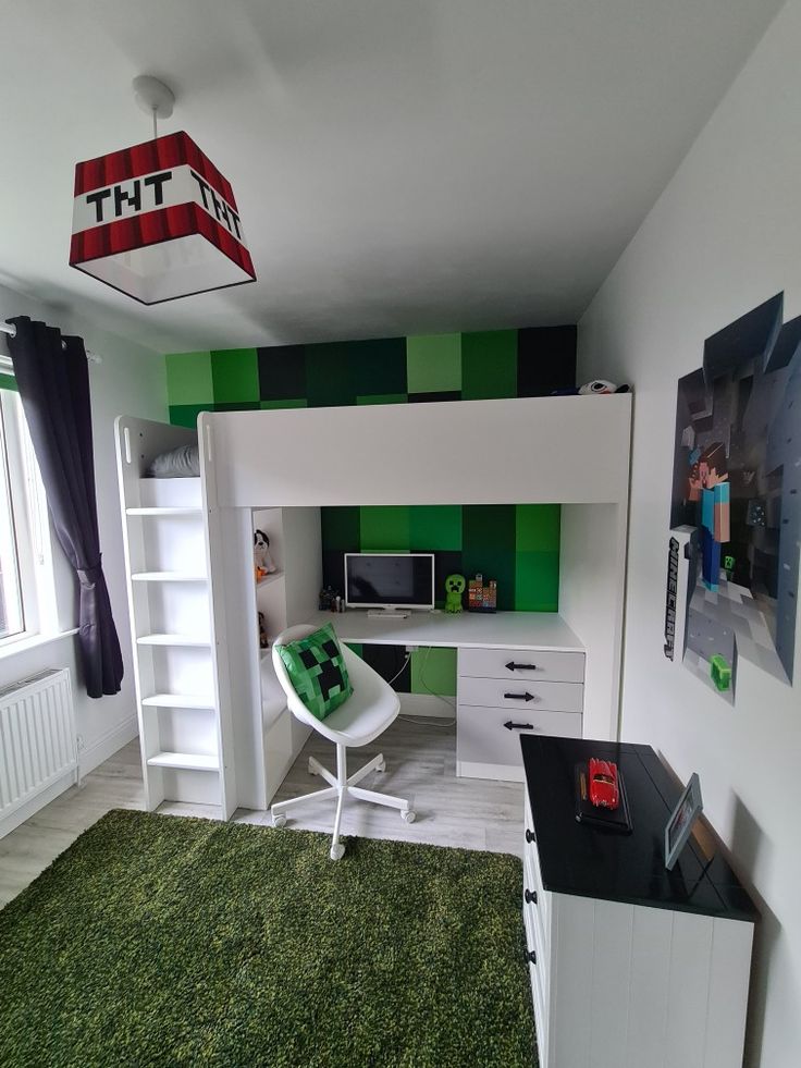 a green and white bedroom with bunk bed, desk and bookcase in the corner