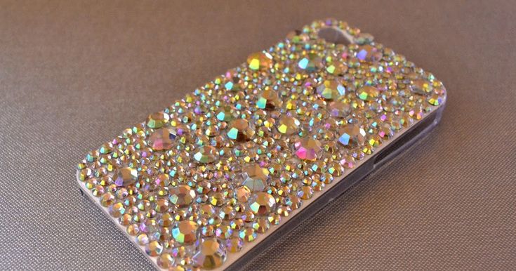 an iphone case with lots of glitter on it