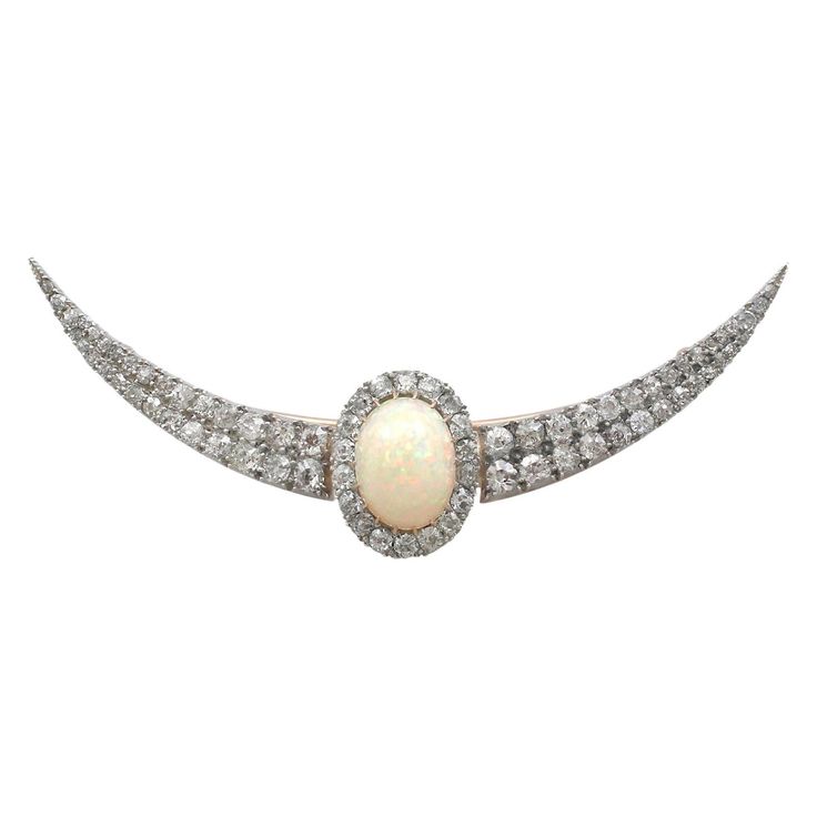 A stunning Victorian 4.75 carat opal and 4.45 carat diamond, 9 karat yellow gold and silver set crescent brooch; part of our diverse antique jewelry collections. This stunning, large, fine and impressive cabochon cut opal and diamond brooch has been crafted in 9k yellow gold with a silver setting. The pierced decorated 9k yellow gold crescent shaped frame is ornamented with a feature 4.75Ct cabochon cut opal, claw/prong set to the center of the design. The opal is surrounded by eighteen Old Euro Gemstone Brooch, Unique Brooch, Bow Brooch, Claw Prong, White Gold Set, Victorian Gold, Antique Brooches, Diamond Brooch, Silver Tops