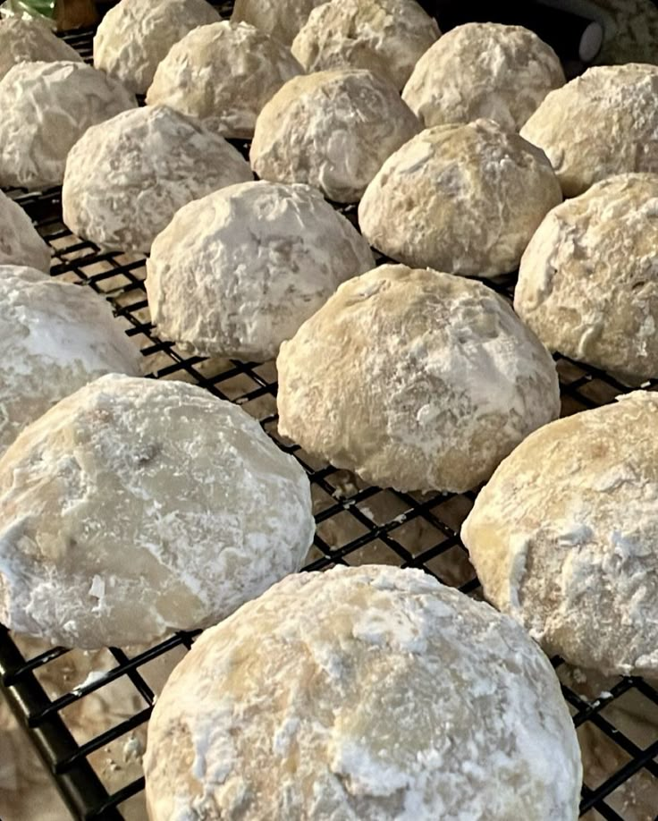 several round breads cooling on a rack