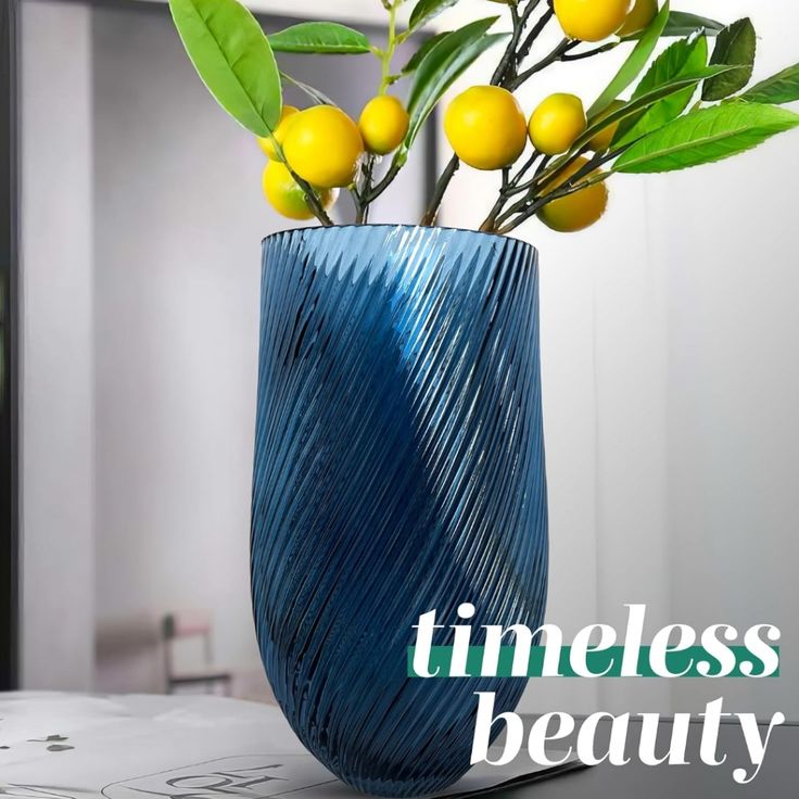 a blue vase filled with yellow flowers on top of a table