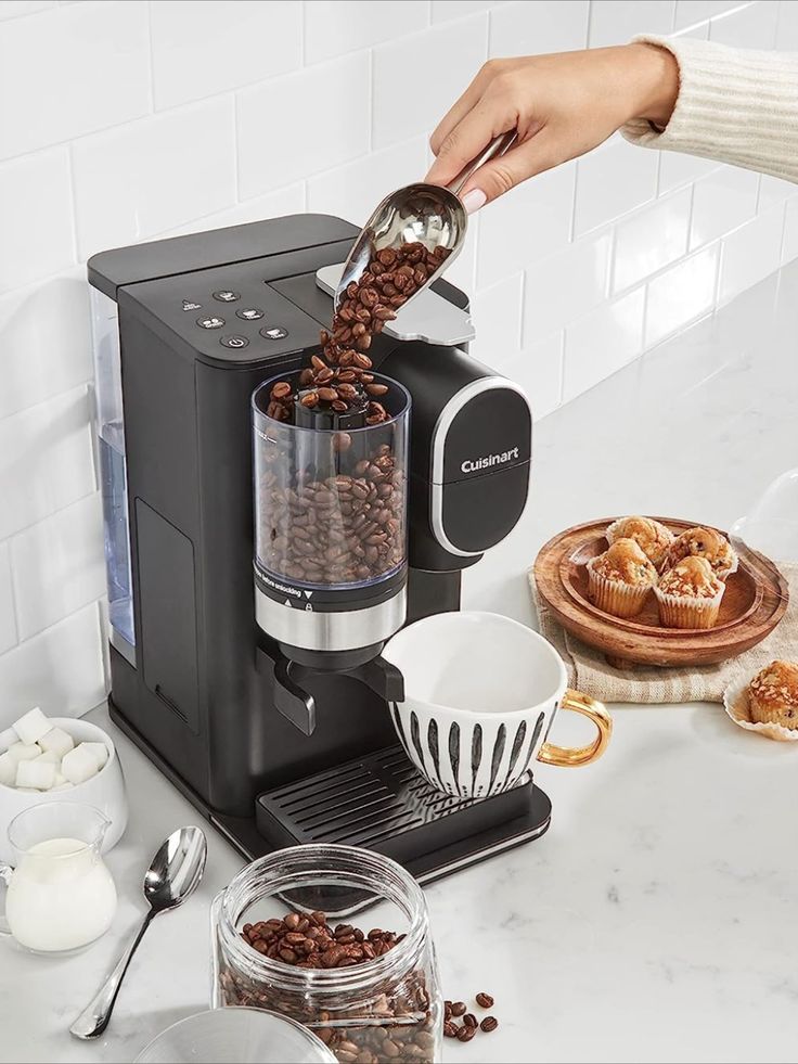 a person pouring coffee into a cup on top of a counter