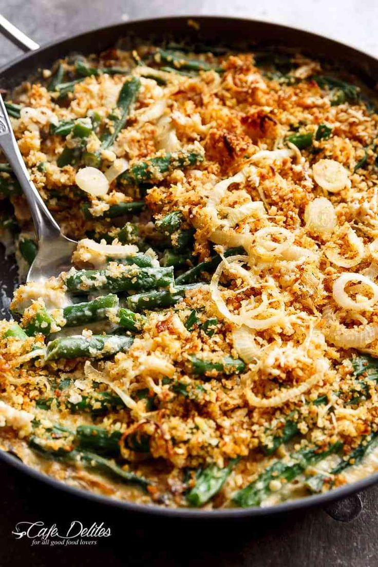 a skillet filled with pasta and green beans