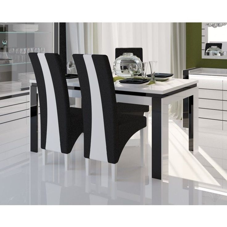 black and white chairs sit at a dining table