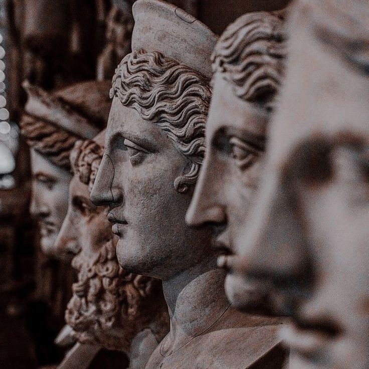 many statues are lined up in a row and one is looking at the other side