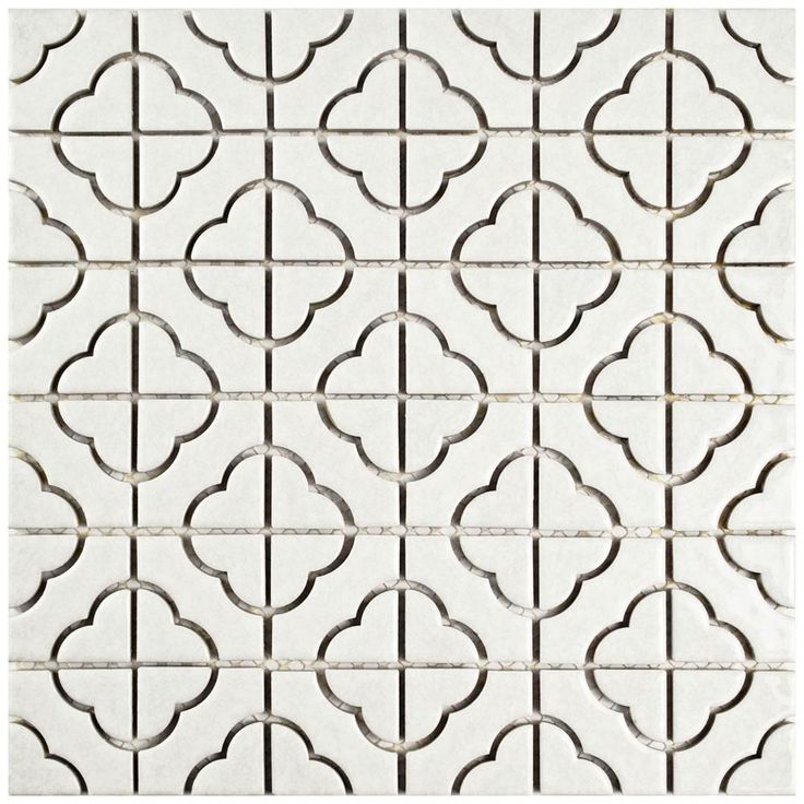 a white tile with an intricate design on the bottom, and a square pattern in the middle