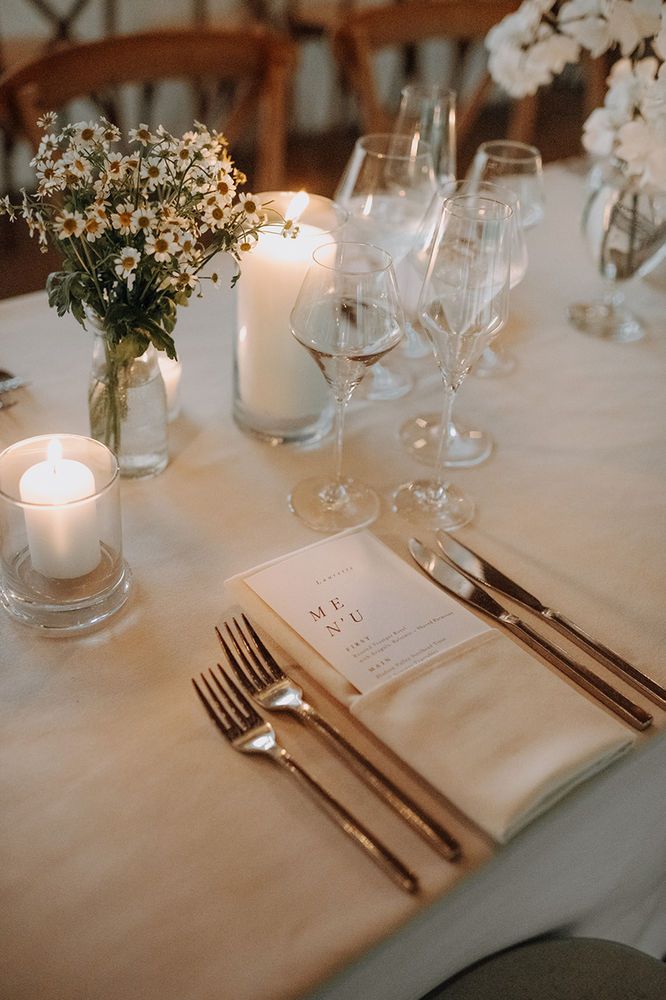 the table is set with silverware and candles