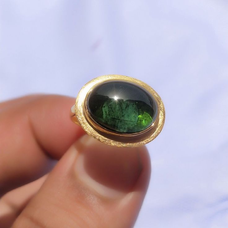 Cabochon Ring Green Tourmaline-14k Gold Cabochon Ring-Tourmaline Ring Women-18k Gold Ring-Statement Ring-Vintage Ring-October birthstone About Ring:- Gemstone = Green Tourmaline  Cabochon Lab [ If You Want Natural Tourmaline Cabochon Just Please message me For Have it At a reasonable Price.]  Gemstone Shape = Oval Cabochon ------------------------------------------------------------------------------------------------------------------------------------------------- Fast Shipping: It will take 1 Yellow Gold Tourmaline Cabochon Ring, Oval Tourmaline Emerald Ring In Yellow Gold, Tourmaline Bezel-set Oval Cabochon Ring, Tourmaline Bezel Set Ring In Oval Cabochon, Tourmaline Ring With Bezel Setting In Oval Cabochon, Oval Tourmaline Emerald Ring With Bezel Setting, Oval Tourmaline Ring For May Birthstone, Oval Tourmaline Emerald Ring For Anniversary, Classic Oval Tourmaline Emerald Ring