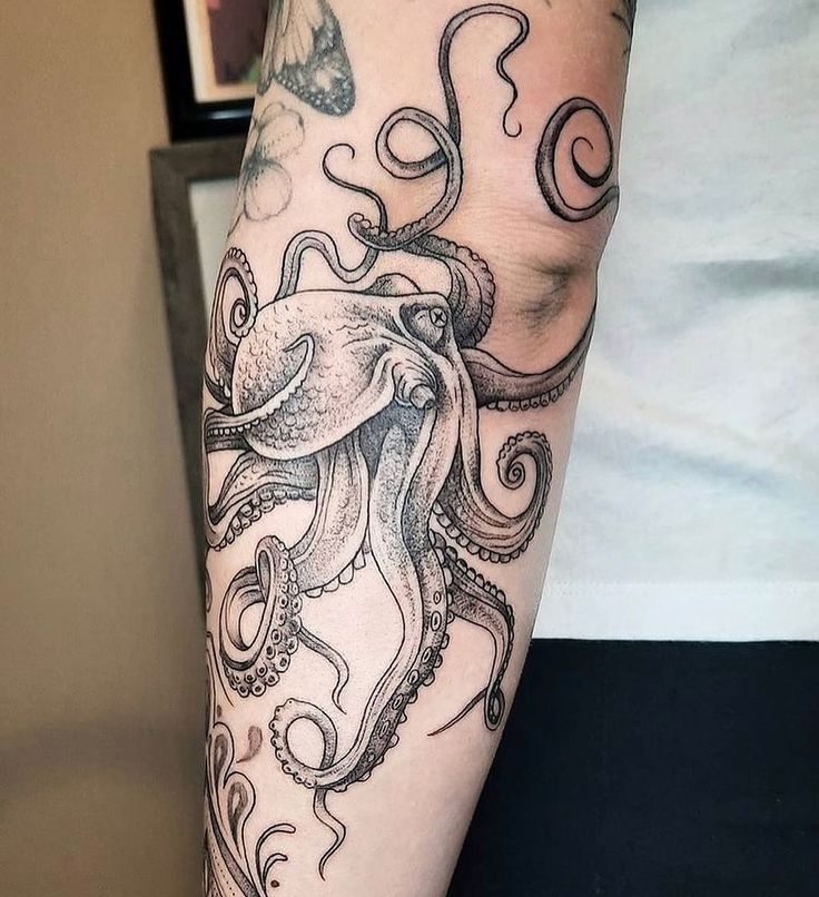 an octopus tattoo on the arm and leg