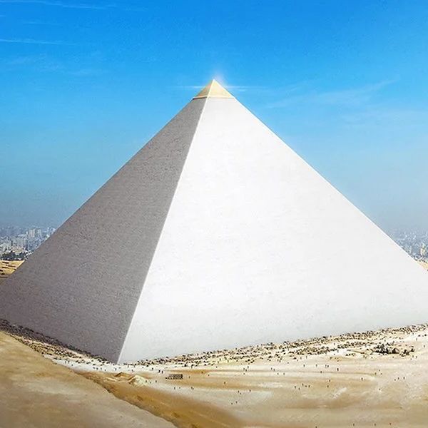 a large white pyramid sitting in the middle of a desert