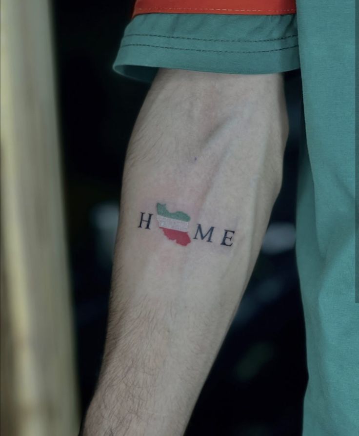 a man with a tattoo on his arm that says home