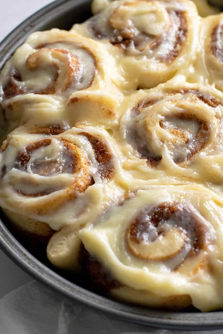 a pan filled with cinnamon rolls on top of a table