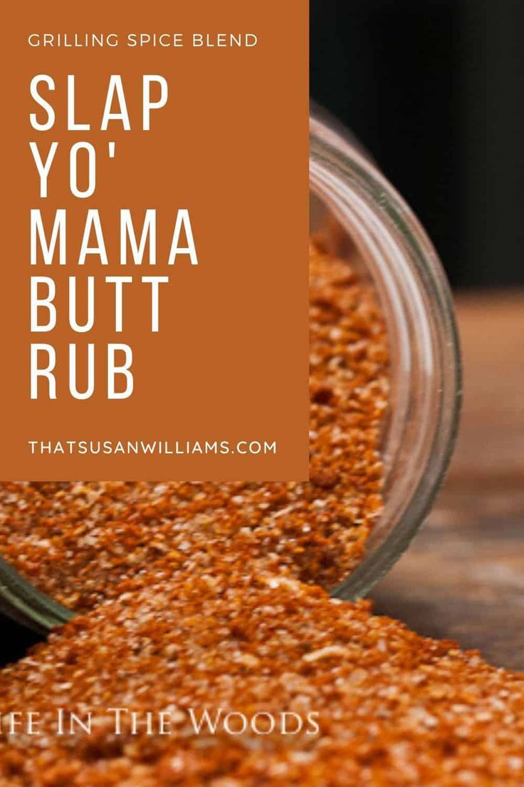 a glass jar filled with red pepper sprinkled on top of a wooden table