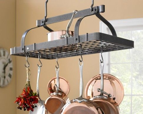 pots and pans are hanging from a rack