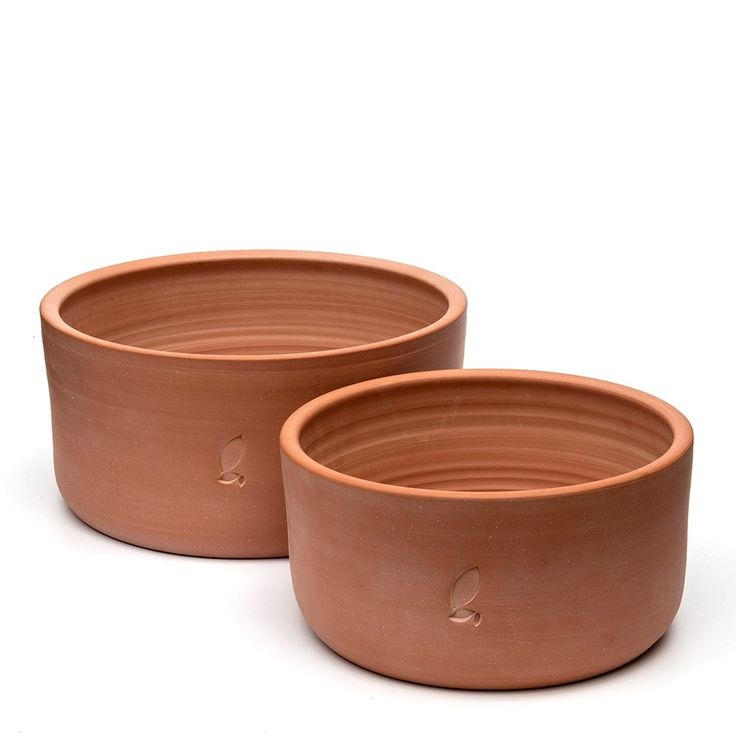 two clay bowls sitting next to each other