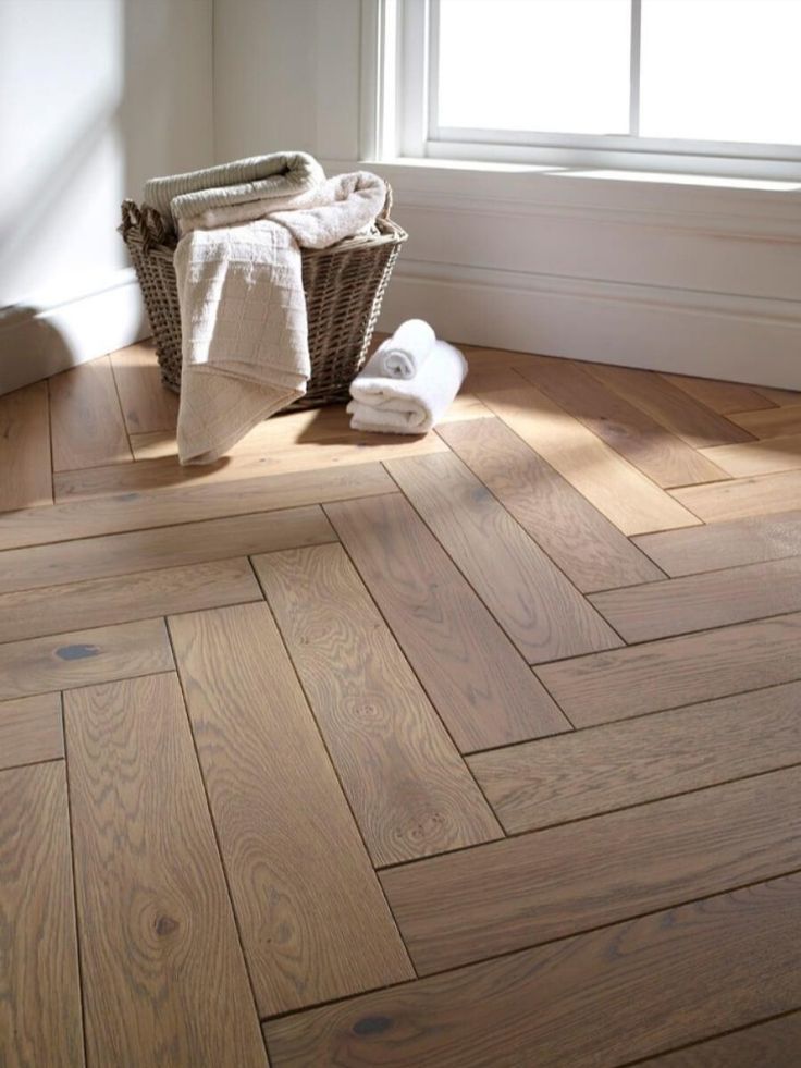 a bathroom with wood flooring and white towels