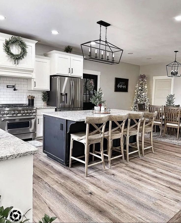 a kitchen filled with lots of counter top space next to a dining room table and chairs