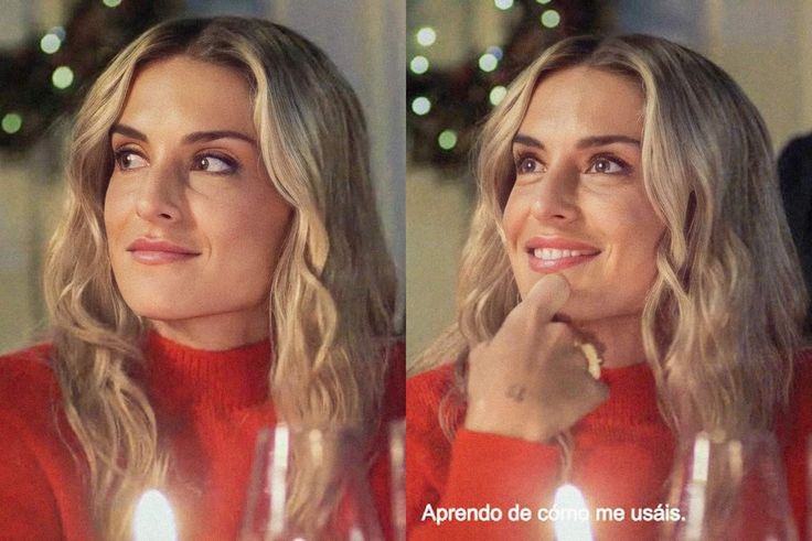 a woman sitting at a table with candles in front of her