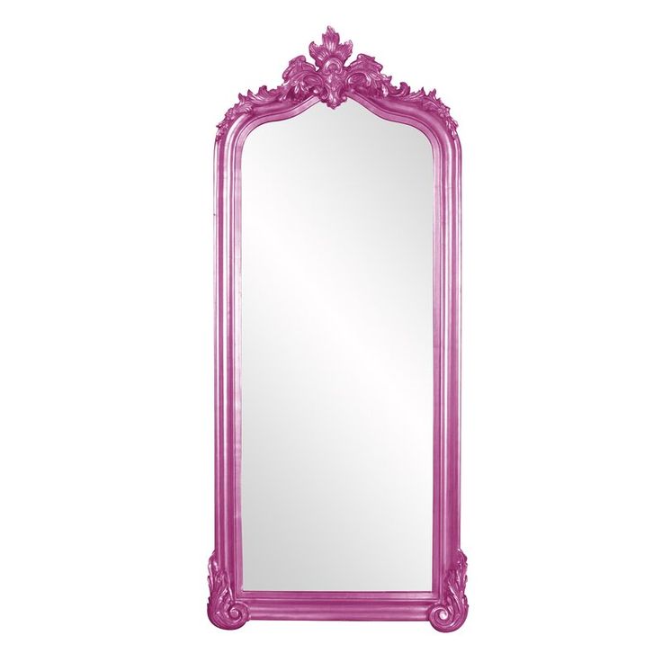 a pink mirror sitting on top of a white wall