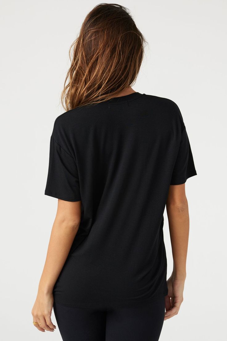 Lightweight, full-length tee with a relaxed fit and a deep v-neckline. This modal tank is ultra comfortable, softer than soft, and breathable. It's a hard-to-beat trio in our famous modal fabric. You'll live in it, and we don't blame you. Color: Black Sizing: S/M (0-4), M/L (6-10) Model is 5'8" and wearing a size S/M Fabric: 92% Micro Modal, 8% Spandex Care: Hand Wash Cold. Lay Flat to Dry. Made in Los Angeles V-neck Athleisure Activewear For Loungewear, Sporty V-neck T-shirt For Loungewear, Black Go-dry Tops For Loungewear, Relaxed Fit V-neck Tops For Relaxation, Short Sleeve Athleisure Tops For Relaxation, Modal V-neck Top For Loungewear, Relaxed Short Sleeve T-shirt For Relaxation, Relaxed Fit V-neck Athleisure Activewear, Casual Black Modal Tops