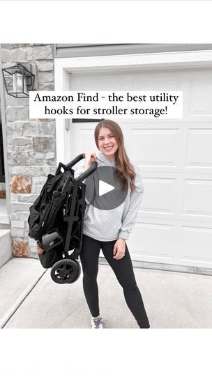 a woman standing in front of a garage holding a stroller with the caption amazon find - the best utility hooks for strollers strong