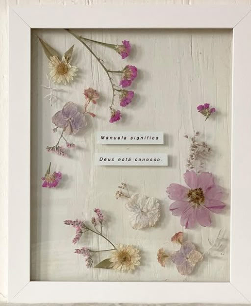 a white frame with pink and purple flowers in it