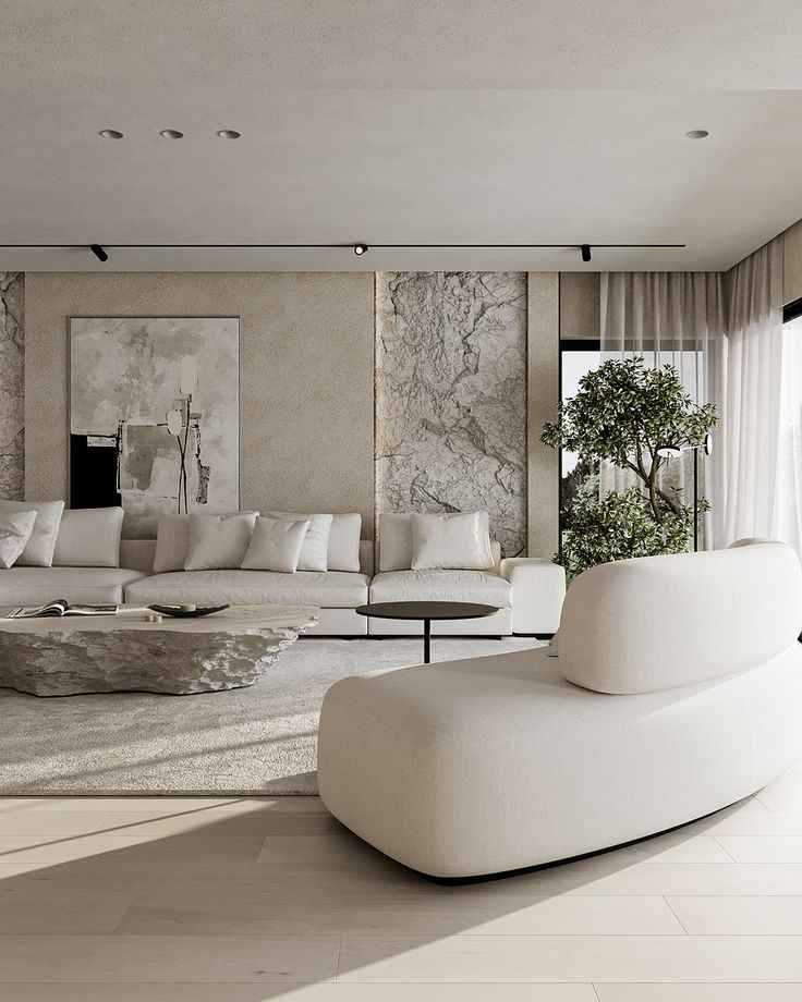 a living room with white furniture and large windows