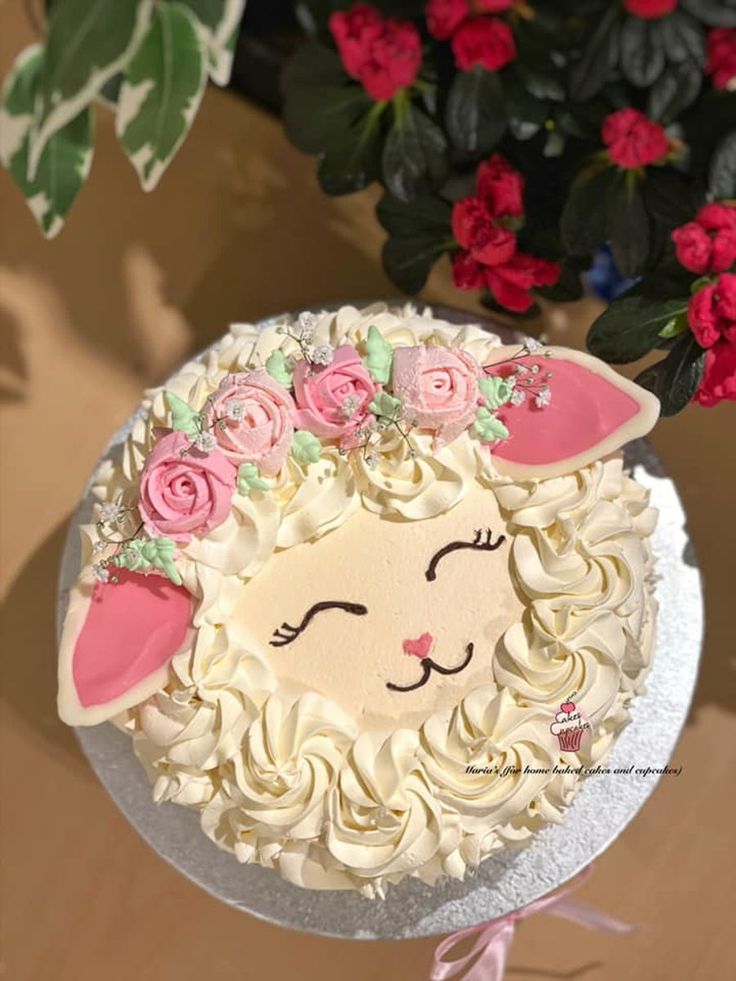 there is a cake decorated with flowers and a sheep face on the top of it