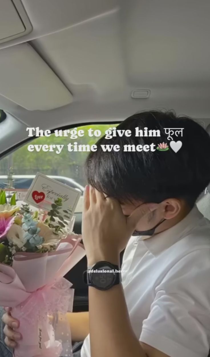 a man sitting in the back seat of a car with flowers and a card on it