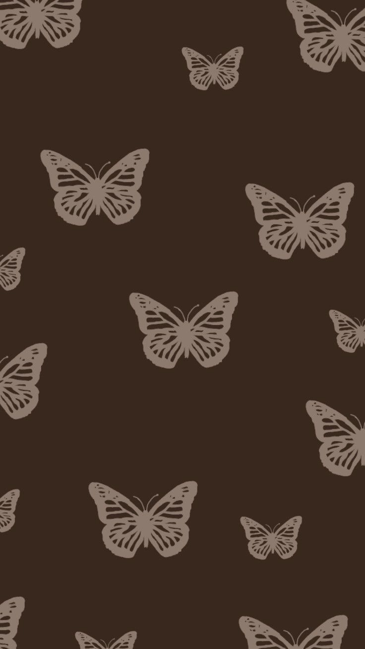 a brown background with white butterflies on it