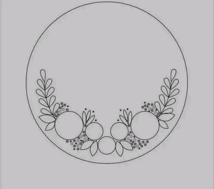 a circle with some flowers and leaves on the side, in black and white ink