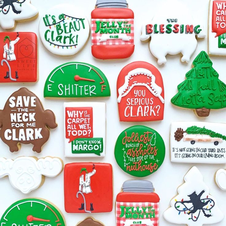 many decorated cookies are displayed on a white surface with green and red lettering in the middle