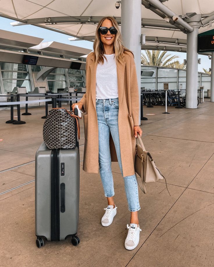 Fashion Jackson Travel Outfit Camel Coatigan White Tshirt Denim Jeans White Sneakers Jeans Travel Outfit, Coatigan Outfit, Airport Outfit Spring, Mom Jeans Outfit Winter, Celine Belt, Camel Coat Outfit, Comfy Travel Outfit, Main Character Energy, Airport Outfits