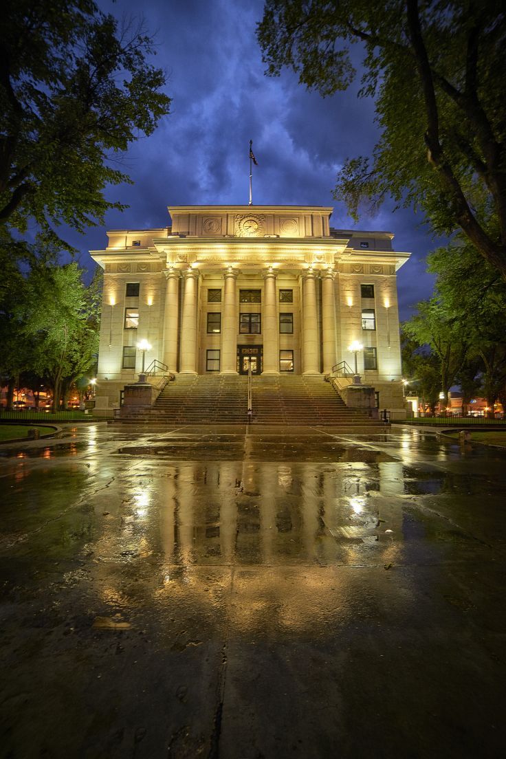 the building is lit up at night with its lights on